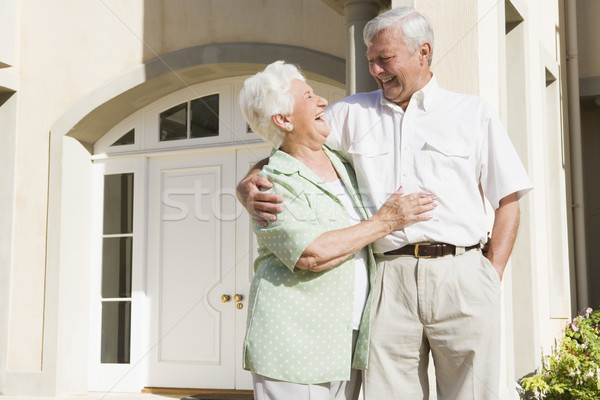 Stock photo: Senior couple standing outside house