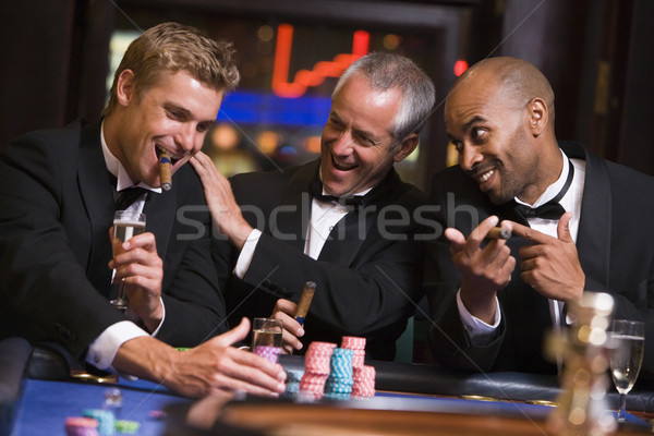 Three men gambling at roulette table Stock photo © monkey_business