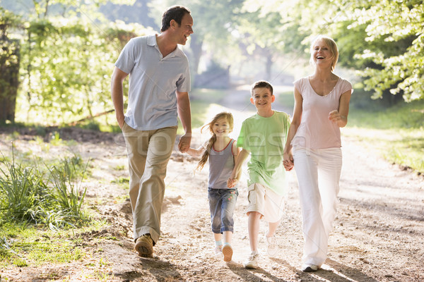 Family running outdoors holding hands and smiling Stock photo © monkey_business
