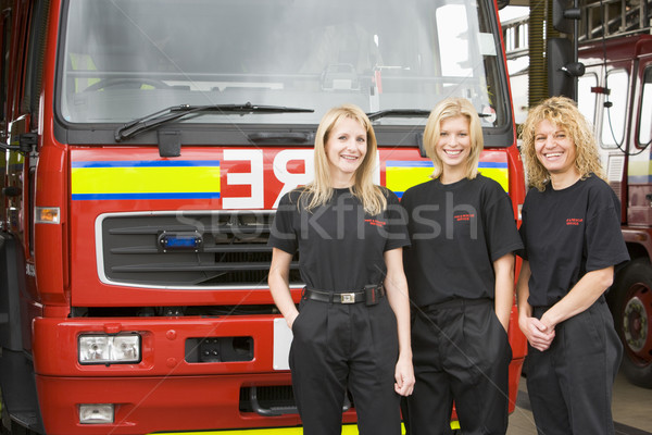 Portrait of firefighters standing by a fire engine Stock photo © monkey_business