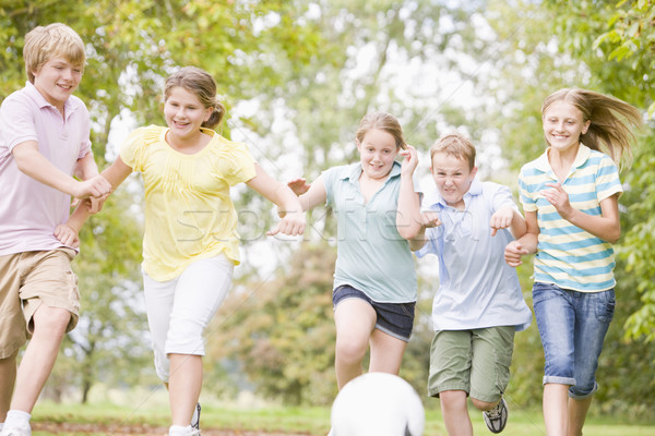 Five young friends playing soccer Stock photo © monkey_business