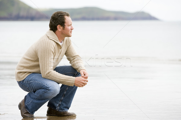 Man crouching on beach Stock photo © monkey_business