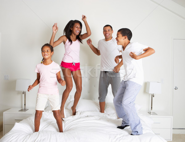 Family Jumping On Bed Together Stock photo © monkey_business