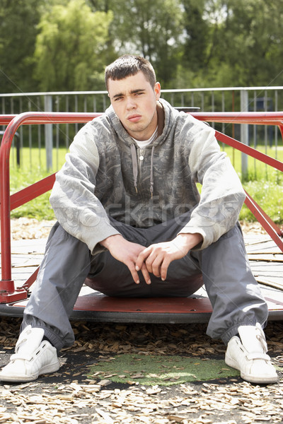 Junger Mann Sitzung Spielplatz Mann traurig einsamen Stock foto © monkey_business