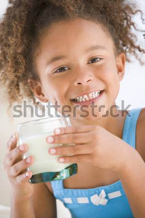 Jeune femme manger yaourt studio femme heureux Photo stock © monkey_business