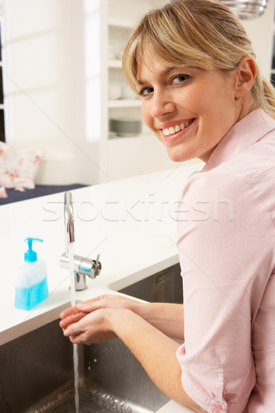 Woman Washing Hands At Kitchen Sink Stock photo © monkey_business