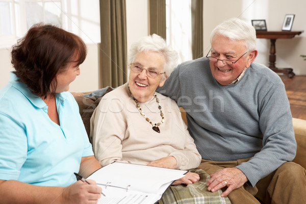 Couple de personnes âgées discussion santé visiteur maison femme Photo stock © monkey_business