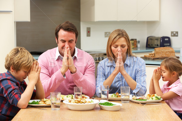 Family saying grace before meal Stock photo © monkey_business