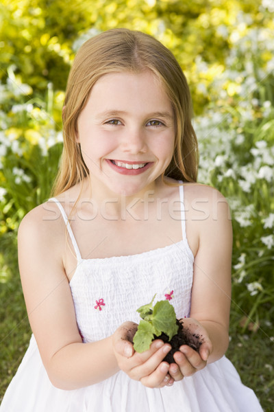 Fiatal lány kint tart növény mosolyog lány Stock fotó © monkey_business