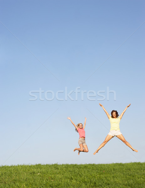 Young women jumping in air Stock photo © monkey_business
