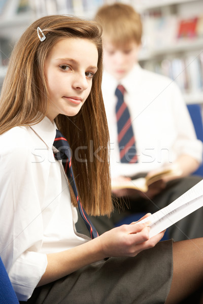 Female Teenage Student In Library Reading Book Stock photo © monkey_business