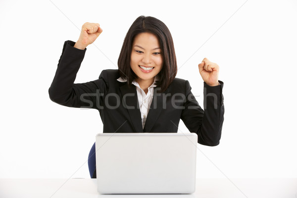 Studio Shot Of Chinese Businesswoman Working On Laptop And Celeb Stock photo © monkey_business