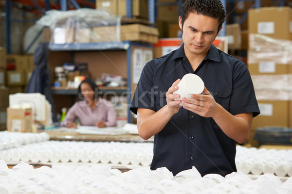 Factory Worker Checking Goods On Production Line Stock photo © monkey_business