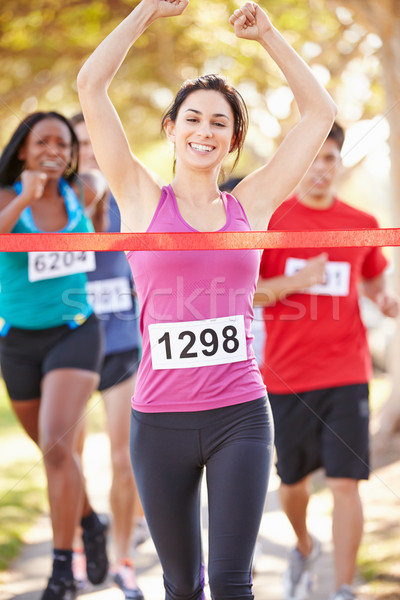 Stock photo: Female Runner Winning Marathon