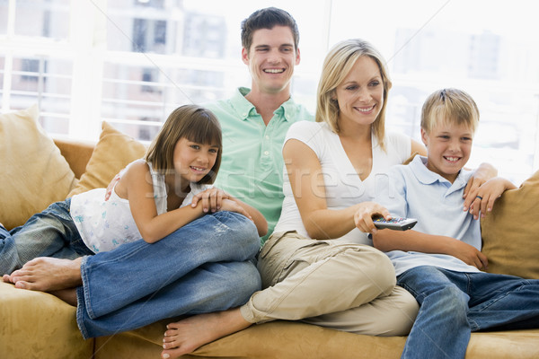 Famiglia seduta soggiorno telecomando sorridere ragazza Foto d'archivio © monkey_business
