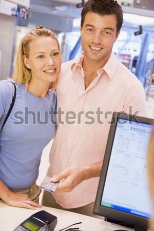 A teacher talks to a schoolgirl using a computer in a high schoo Stock photo © monkey_business