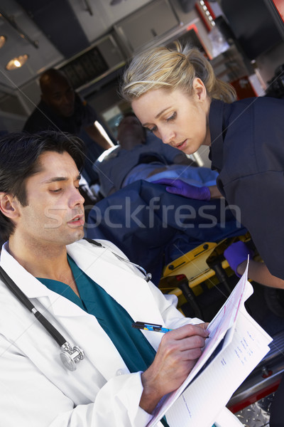Paramedic advising doctor about arriving patient Stock photo © monkey_business