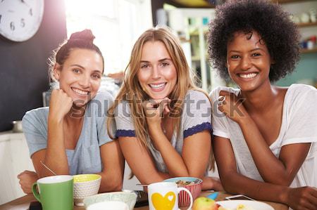 Teenage Girls Sitting Outdoors Eating Fast Food  Stock photo © monkey_business