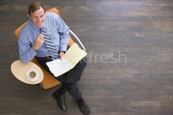üzletember ül bent kávé mappa mosolyog Stock fotó © monkey_business