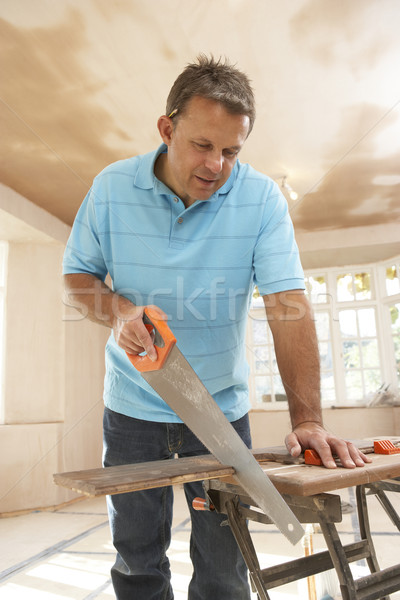 Builder Sawing Wood On Workbench Stock photo © monkey_business