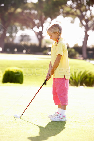 Young Girl Practising Golf On Putting On Green Stock photo © monkey_business