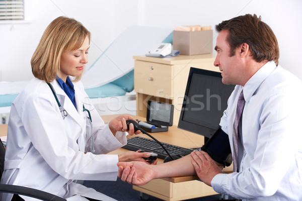 American doctor taking patient's blood pressure Stock photo © monkey_business
