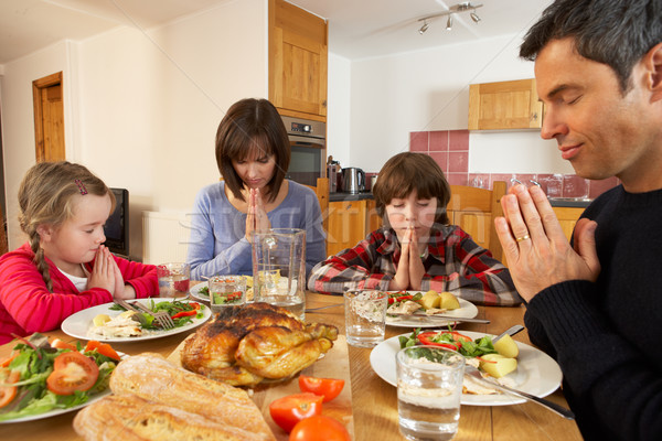 Family Saying Grace Before Eating Lunch Together In Kitchen Stock photo © monkey_business