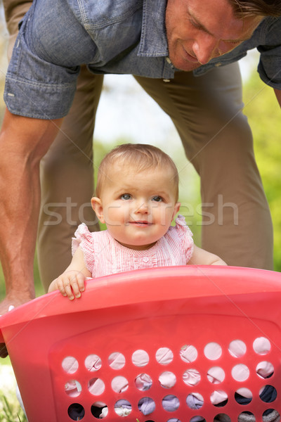 Father Carrying Baby Girl Sitting In Laundry Basket Stock photo © monkey_business