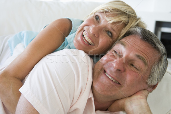 Stock photo: Couple relaxing in living room smiling