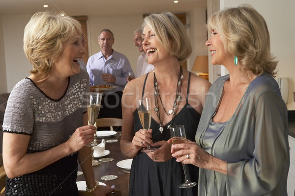 Friends Enjoying A Glass Of Champagne At A Dinner Party Stock photo © monkey_business