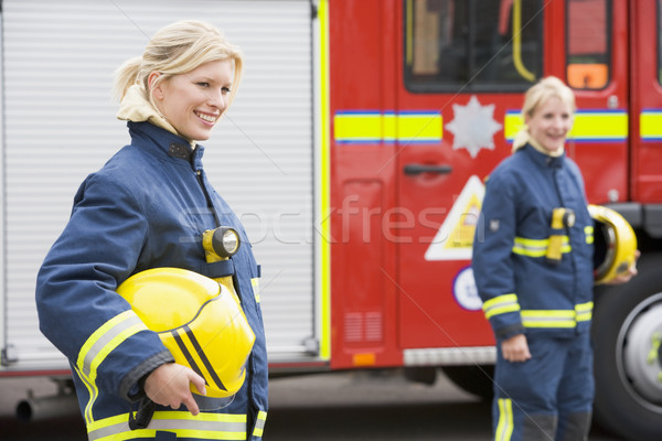 Two female firefighters by a fire engine Stock photo © monkey_business