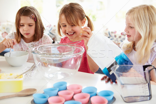 Three Girls Making Cupcakes In Kitchen Stock photo © monkey_business