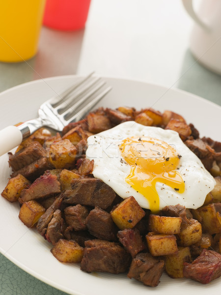 Corned Beef Hash with a Broken Fried Egg and Black Pepper Stock photo © monkey_business
