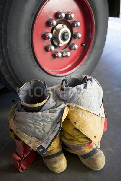 Empty firefighter's boots and uniform next to fire engine Stock photo © monkey_business