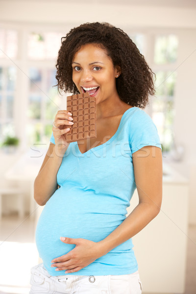 Pregnant woman eating chocolate Stock photo © monkey_business