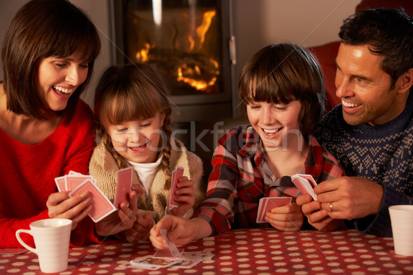 Portrait Of Family Playing Cards By Cosy Log Fire Stock photo © monkey_business