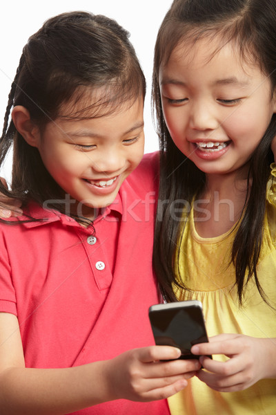 два китайский девочек мобильного телефона девушки Сток-фото © monkey_business