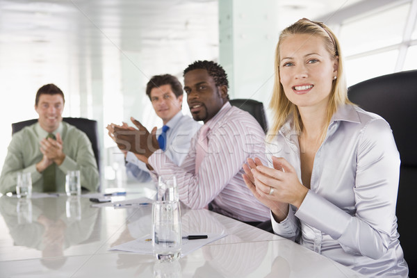 Four businesspeople in a boardroom applauding Stock photo © monkey_business