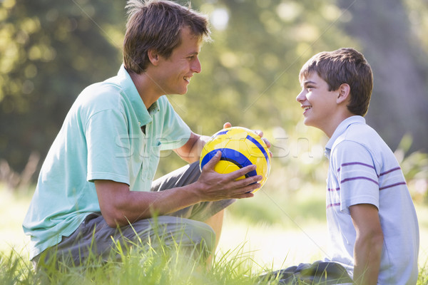 Man and young boy outdoors with soccer ball smiling Stock photo © monkey_business