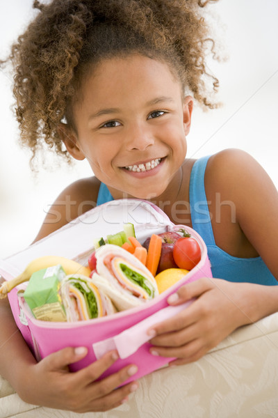 Junge Mädchen halten Mittagessen Wohnzimmer lächelnd Mädchen Stock foto © monkey_business