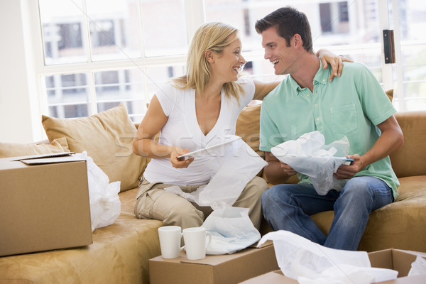 Couple unpacking boxes in new home smiling Stock photo © monkey_business