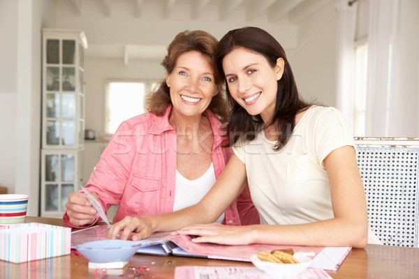 Adult mother and daughter scrapbooking Stock photo © monkey_business
