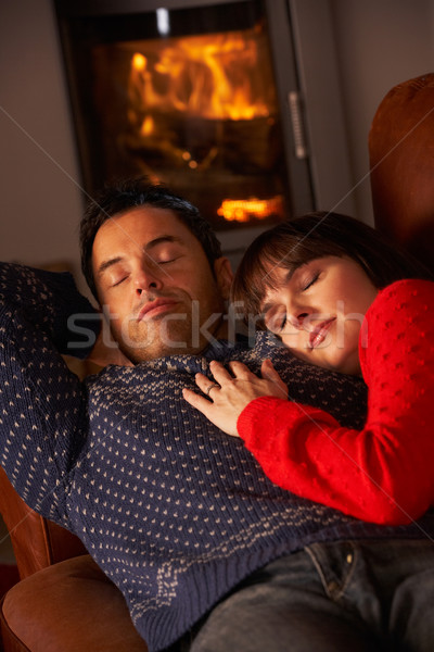 Középkorú pár ölelkezés kanapé kényelmes tűz Stock fotó © monkey_business