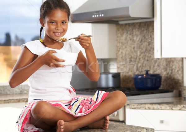 Girl In Kitchen Eating Bowl Of Breakfast Cereal Stock photo © monkey_business