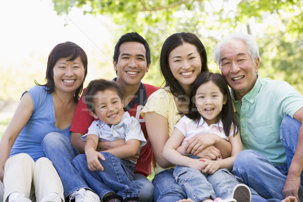 Extended family sitting outdoors smiling Stock photo © monkey_business