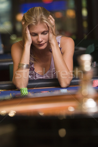 Woman losing at roulette table Stock photo © monkey_business