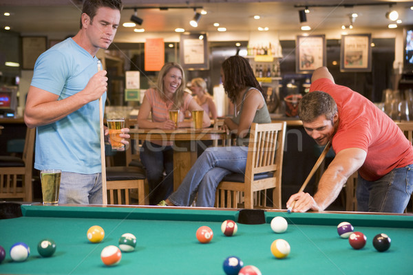 Zwei junge Männer spielen Pool bar Frauen Stock foto © monkey_business