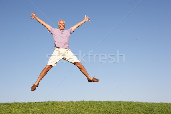 Senior man jumping in air Stock photo © monkey_business