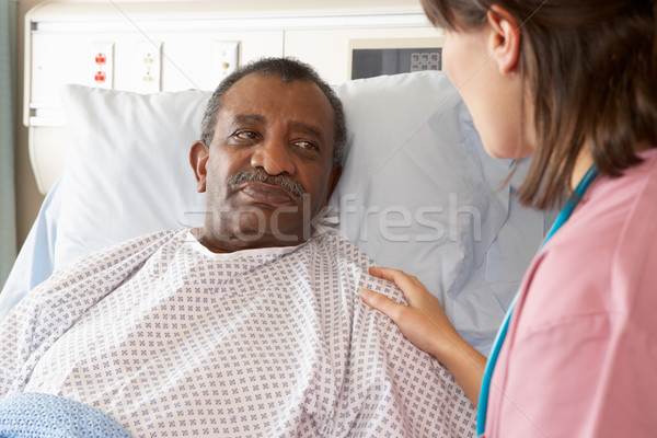 Nurse Talking To Senior Male Patient On Ward Stock photo © monkey_business