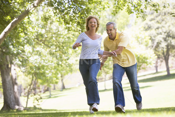 Foto stock: Casal · corrida · ao · ar · livre · parque · sorridente · mulher